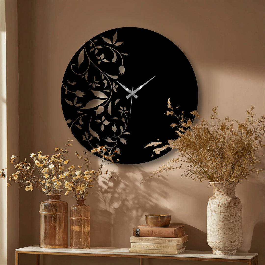 High color contrast accentuates the black and gold floral metal wall clock, a stunning piece of decorative metal art with an elegant, minimal leaf design.