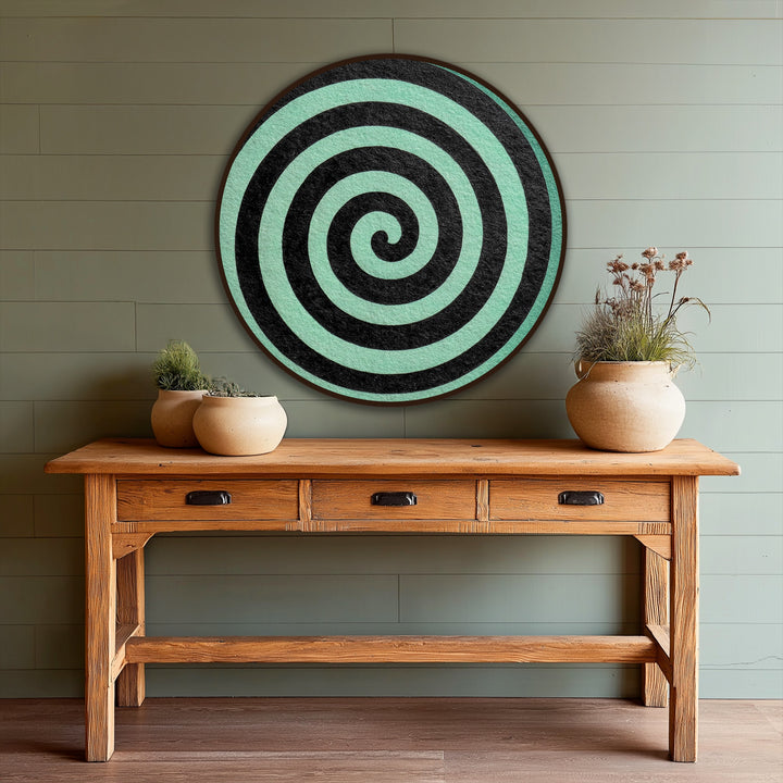 The stillness in the round, minimalist modern oil painting art highlights the spiraling black design against a serene mint background.