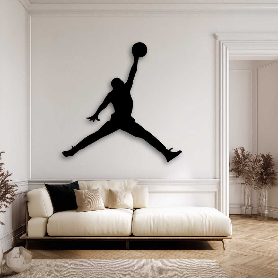 The powerful stillness of a basketball player's jump, rendered as striking metal wall decor, anchors the calm, minimalist room.