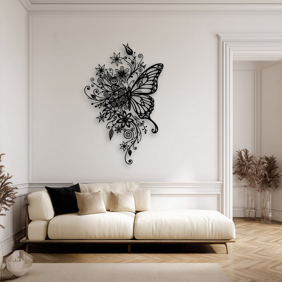 The focal point is an intricate black floral butterfly metal wall art piece, showcasing decorative metal art on a bright white wall above a beige sofa.