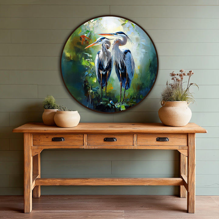 Backlit area highlights the exquisite details of the heron pair in this round oil painting artwork, showcasing a unique rendition of wildlife in nature.