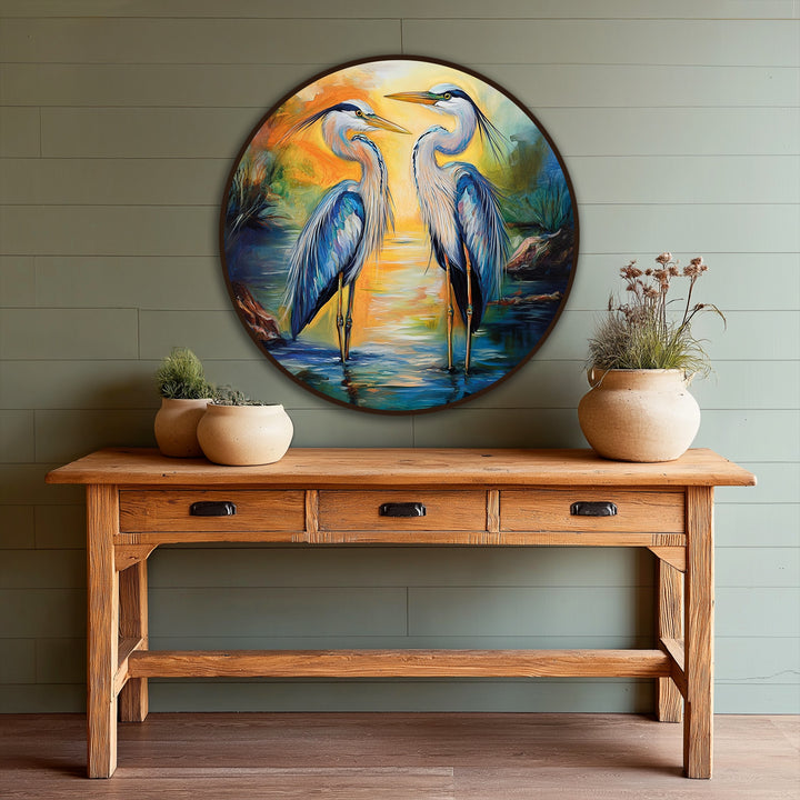 Framed by a rich, dark border, this circular Sunset Reflections oil painting decoration captures two graceful herons amidst a tranquil waterscape.