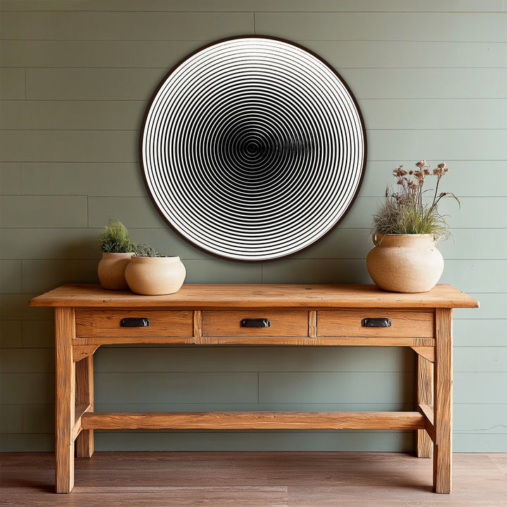 Framed with a sleek wooden edge, this hypnotic lines minimalist round oil painting art prints wall art features a striking contrast between the white backdrop and dark lines.