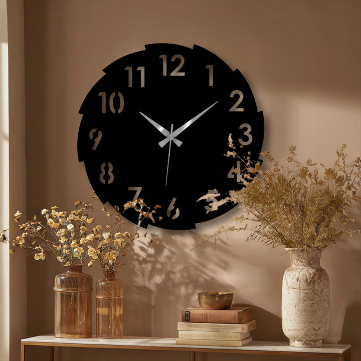 Featuring a matte black finish, this segmented modern number design metal wall clock offers a striking display of unique metal wall art.