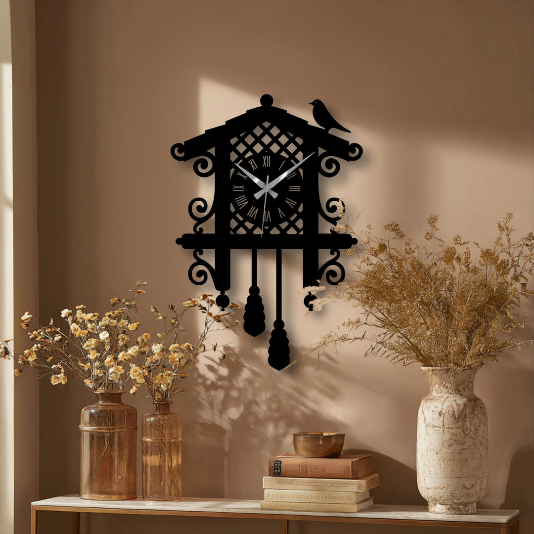 Geometric decorative metal art defines this Cuckoo wall clock, featuring symmetrical lines, circular embellishments, and a stylized bird silhouette.
