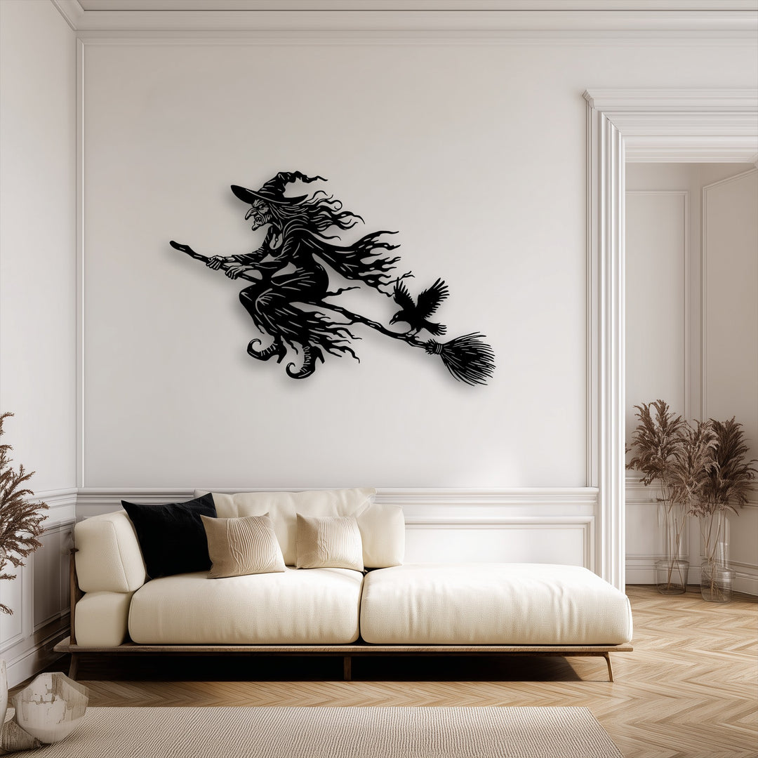 The visual rhythm of the stylized witch and broom creates dynamic decorative metal art, enhanced by the crow's flight.