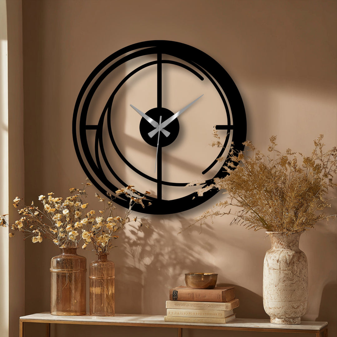 The darkest area of the modern spiral metal wall clock highlights the striking geometric design as a piece of decorative metal art, contrasting against the softer wall tones.