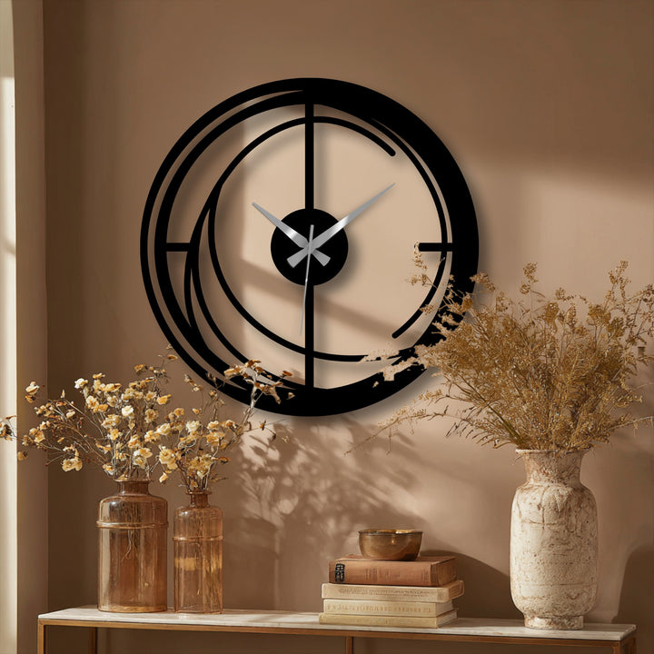 The darkest area of the modern spiral metal wall clock highlights the striking geometric design as a piece of decorative metal art, contrasting against the softer wall tones.
