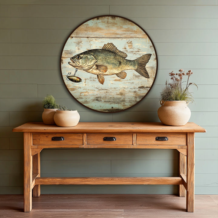 Rustic oil painting decoration featuring a vintage bass fish on a round wooden surface with a distressed, weathered finish.