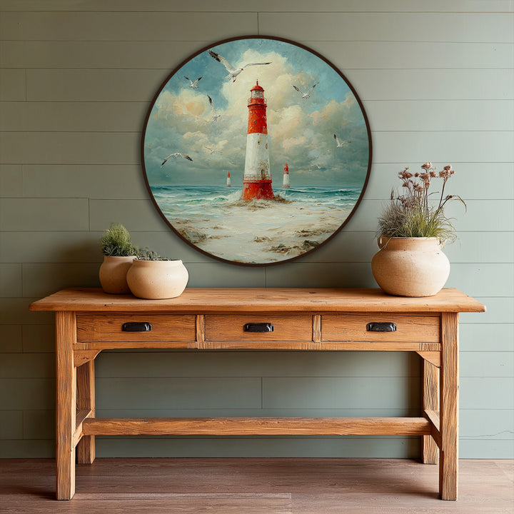 Rustic wooden console table displays round coastal beacon oil painting with seagulls and ocean waves, enhancing its oil painting home decor appeal.