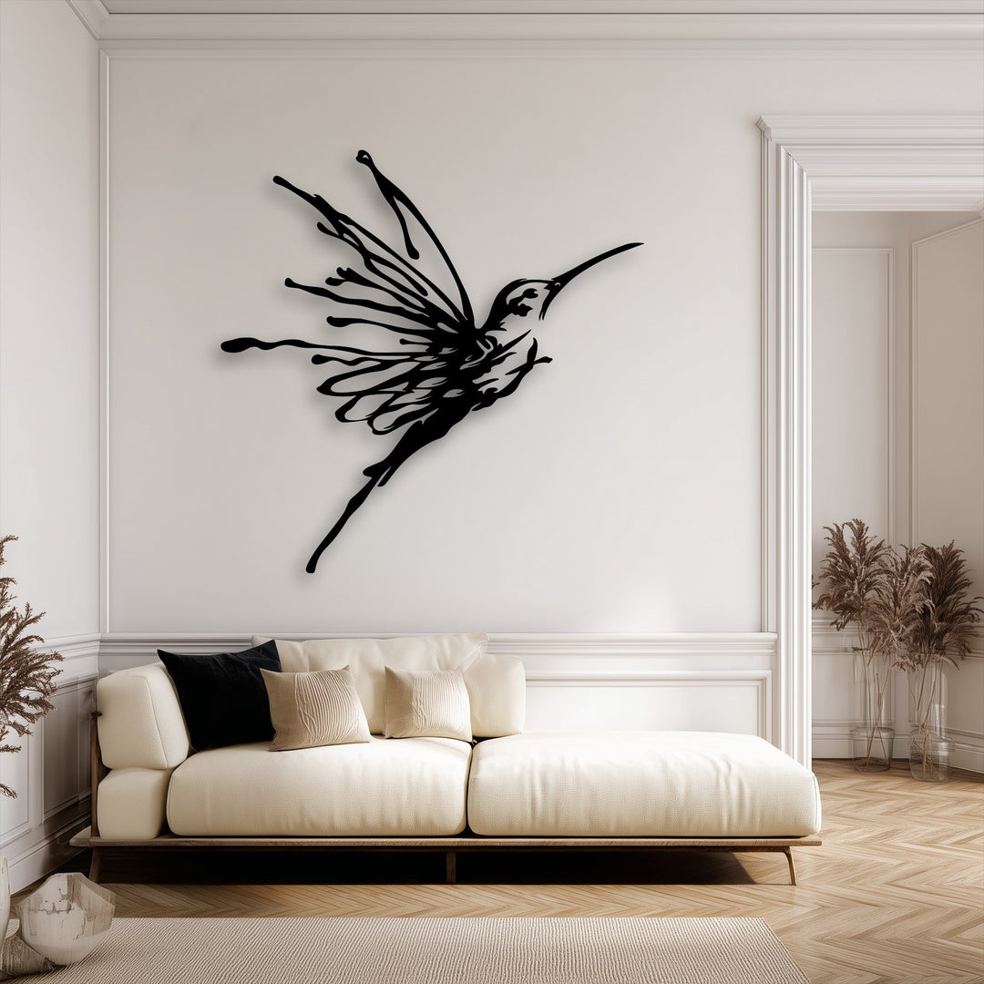 The sharp color contrast highlights the elegant black flying hummingbird decorative metal art against the light ivory wall.