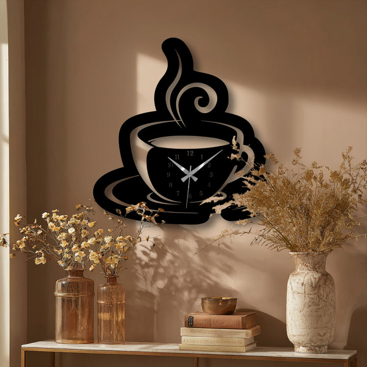 A vertically oriented, stylized coffee cup silhouette with swirling steam forms this decorative black metal artwork wall clock.