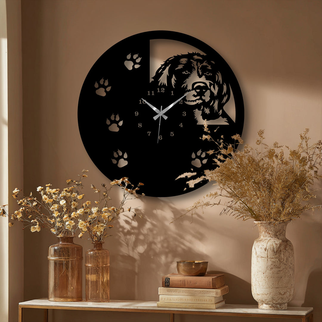 Wispy, light brown dried flowers softly accent the unique metal wall art dog silhouette clock with paw print design.