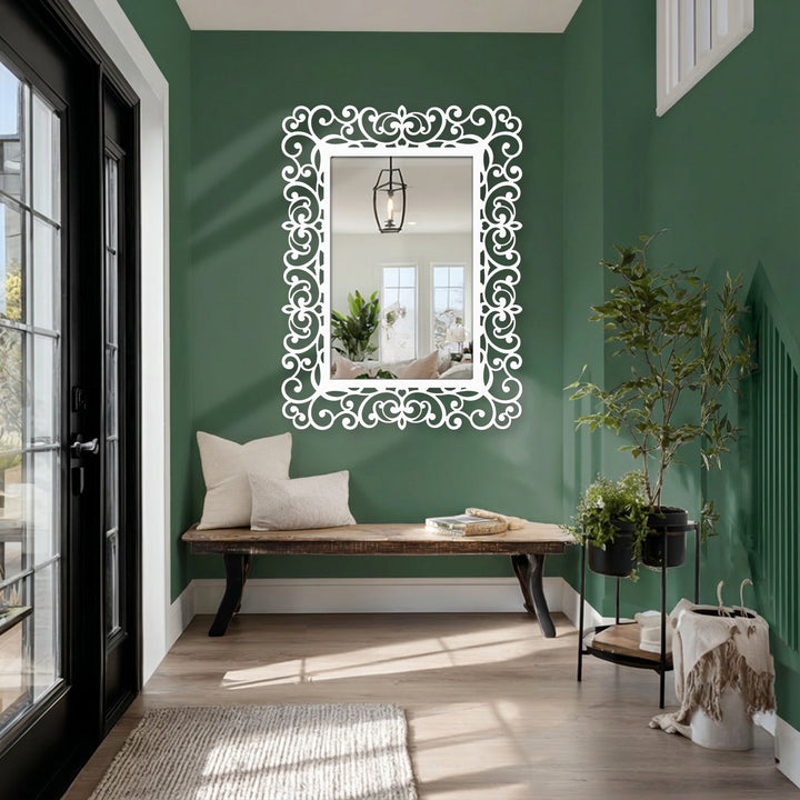 Vertical rectangular framed wall mirror featuring an ornamental black frame with an elegant baroque scroll design.