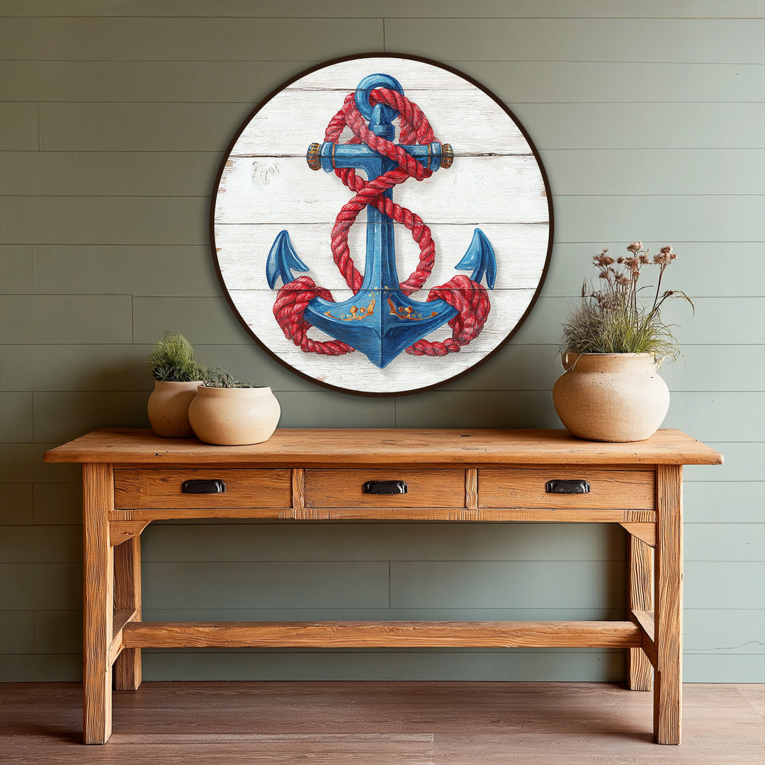The hand-painted nautical anchor, the central subject of this oil painting art piece, is encircled by a vibrant red rope against a weathered, wooden background.