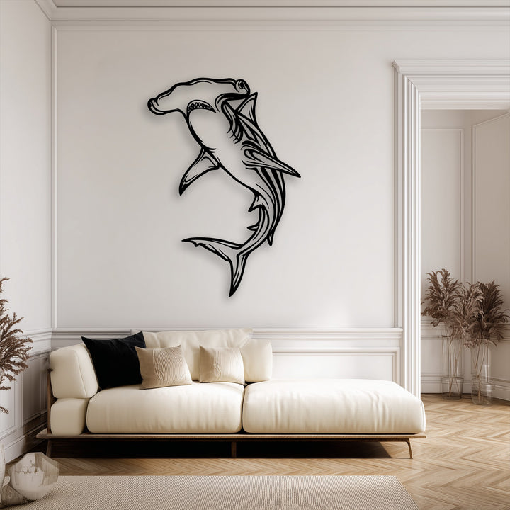The soft, warm color temperature of the interior design beautifully complements the bold Hammerhead Shark metal wall decor.