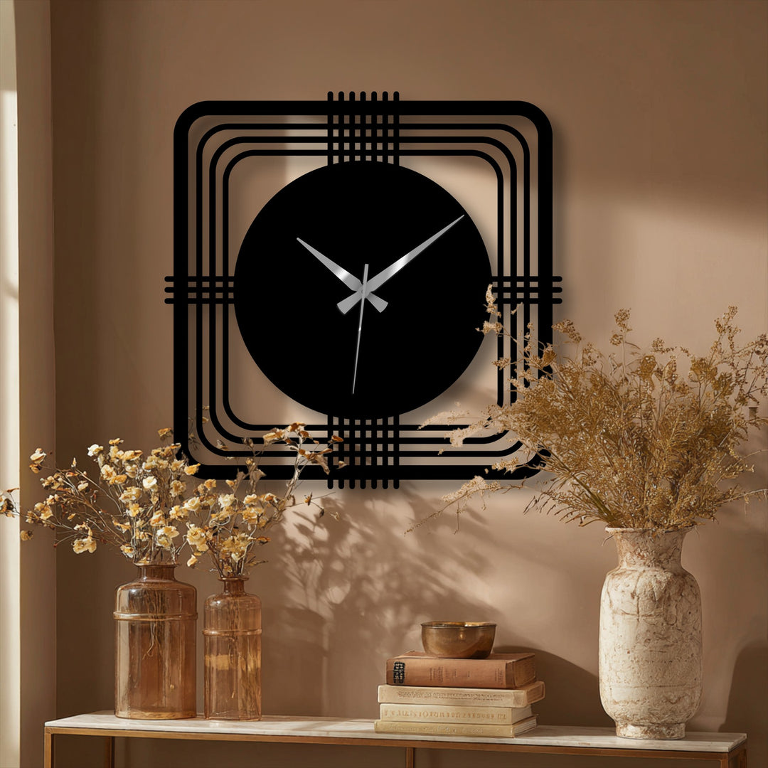 The darkest area of the geometric square frame highlights the sleek, black circle of this unique metal artwork wall clock, a modern statement piece.