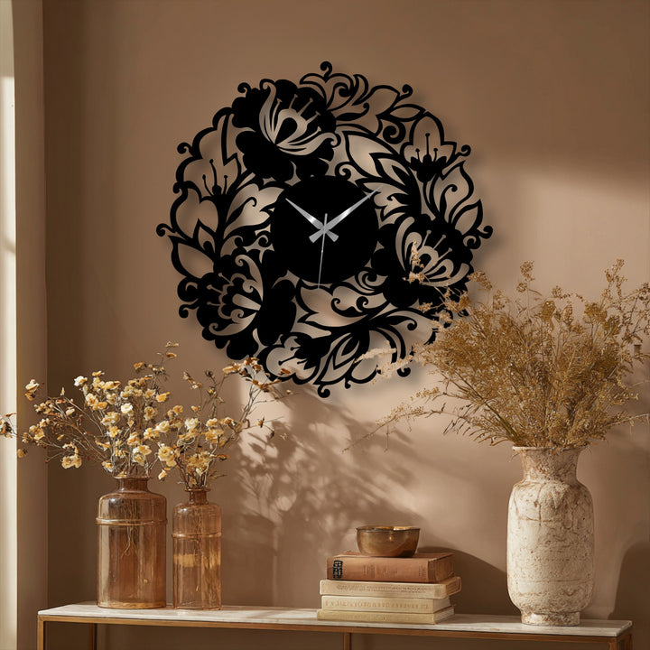 Warm light illuminates the elegant botanical metal art for wall, creating sharp, captivating shadows of the ornate floral wreath clock.