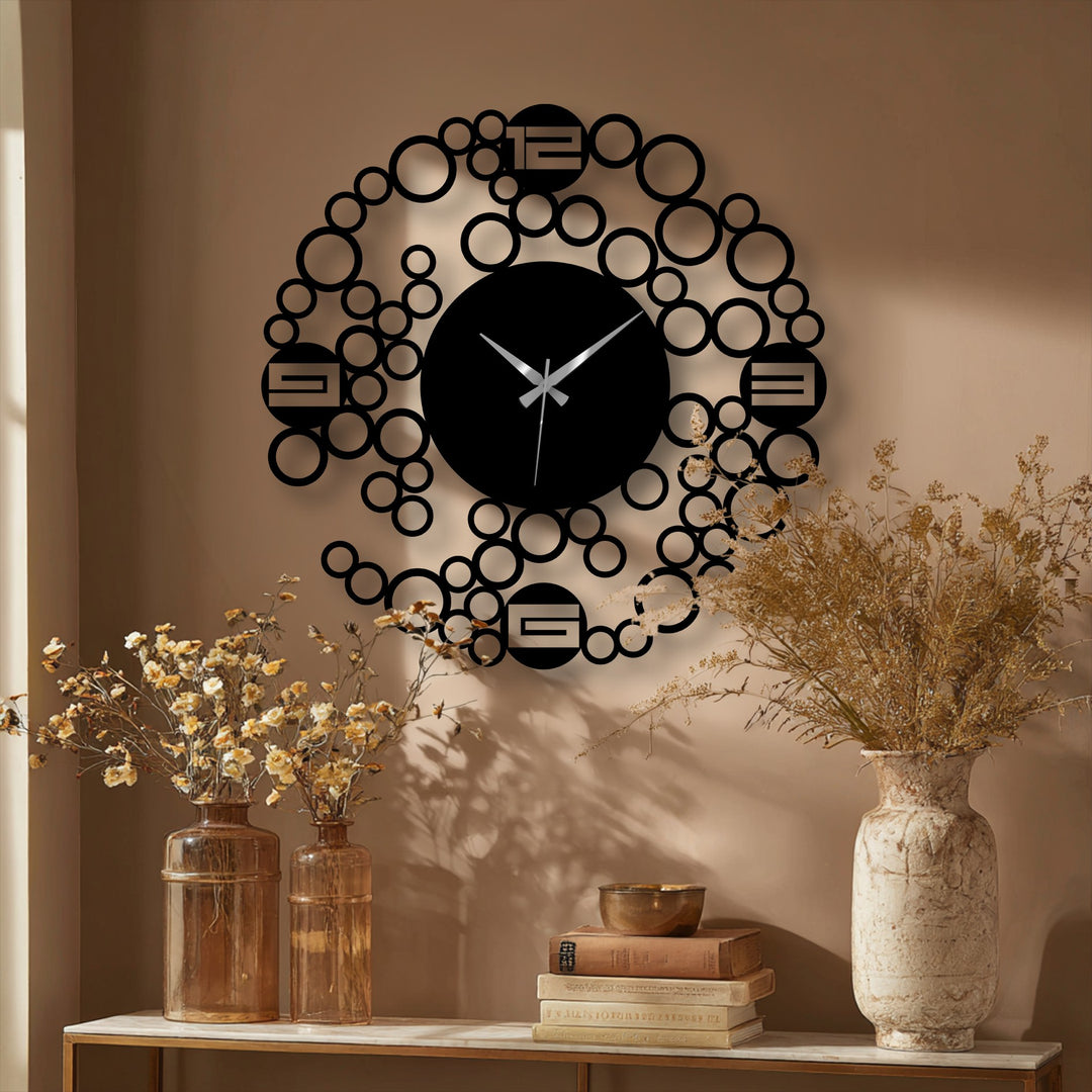 Depth is created in this geometric clock's design through layered rings, providing a unique take on metal wall decor.