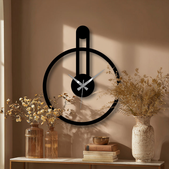 Highlighting the edge, this minimalist round metal wall clock showcases its sleek black borders as a unique piece of metal artwork with a modern vertical accent.