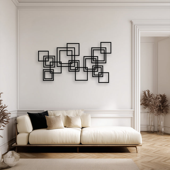 The striking, clean edges of the geometric interlocking squares in this unique metal wall art create a captivating border-like display on the pristine wall.