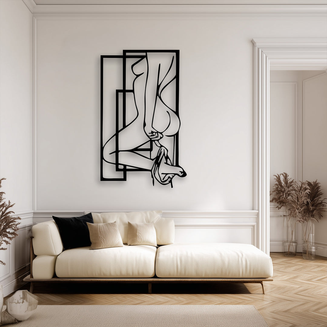 Creamy white walls showcasing an elegant abstract feminine silhouette metal wall decor art piece in a modern living space.