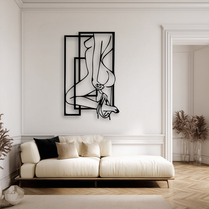 Creamy white walls showcasing an elegant abstract feminine silhouette metal wall decor art piece in a modern living space.
