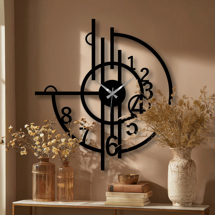 Soft, muted light enhances the abstract geometric design of this modern metal artwork clock, casting gentle shadows on the wall behind it.