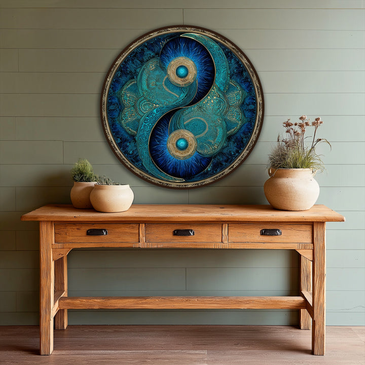 Warm light highlights the turquoise and gold tones of this circular oil painting artwork, casting a glow on the eternal balance of the yin and yang.
