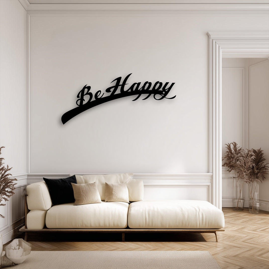 The brightest area showcases the elegant black 'Be Happy Script' metal wall art, an inspiring decoration wall art piece on a white wall.
