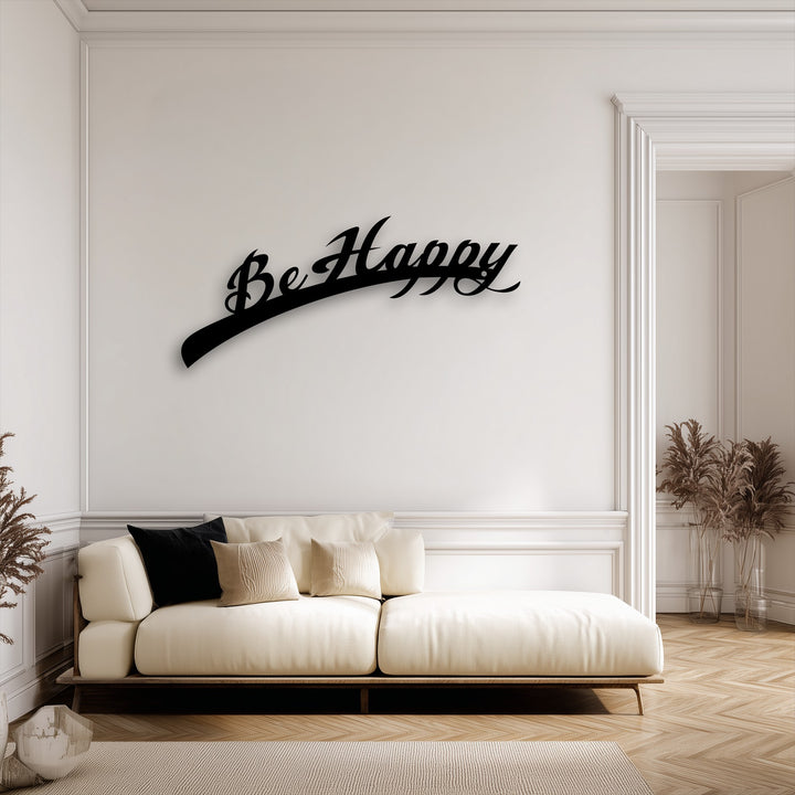 The brightest area showcases the elegant black 'Be Happy Script' metal wall art, an inspiring decoration wall art piece on a white wall.