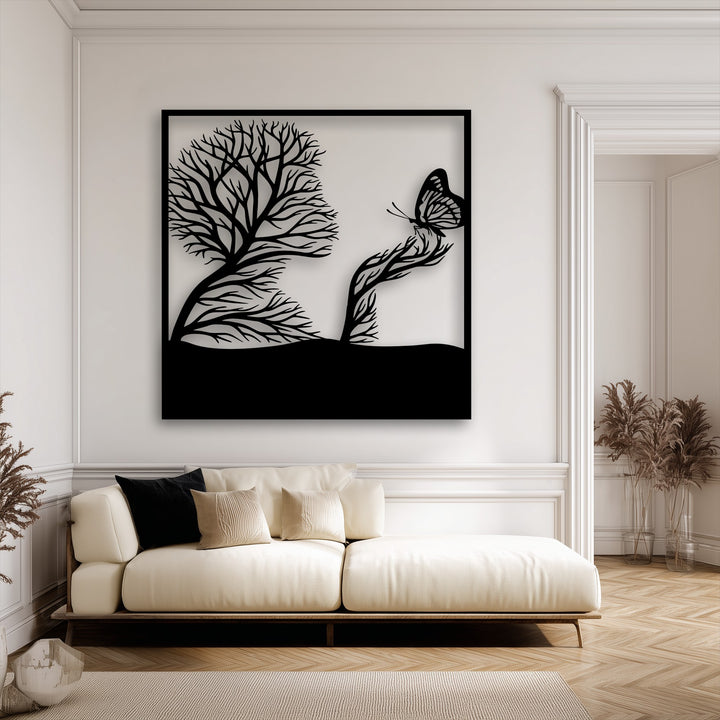 A unique metal wall art piece showcasing a whimsical black silhouette of a tree and a butterfly landing on a branch, beautifully framed.