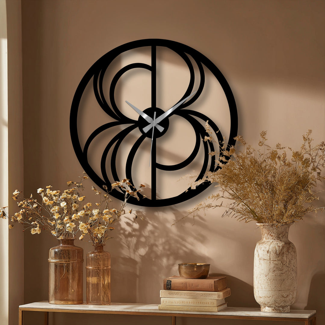 With muted color saturation, the metal artwork of an abstract swirl wall clock showcases its modern geometric design and decorative appeal.