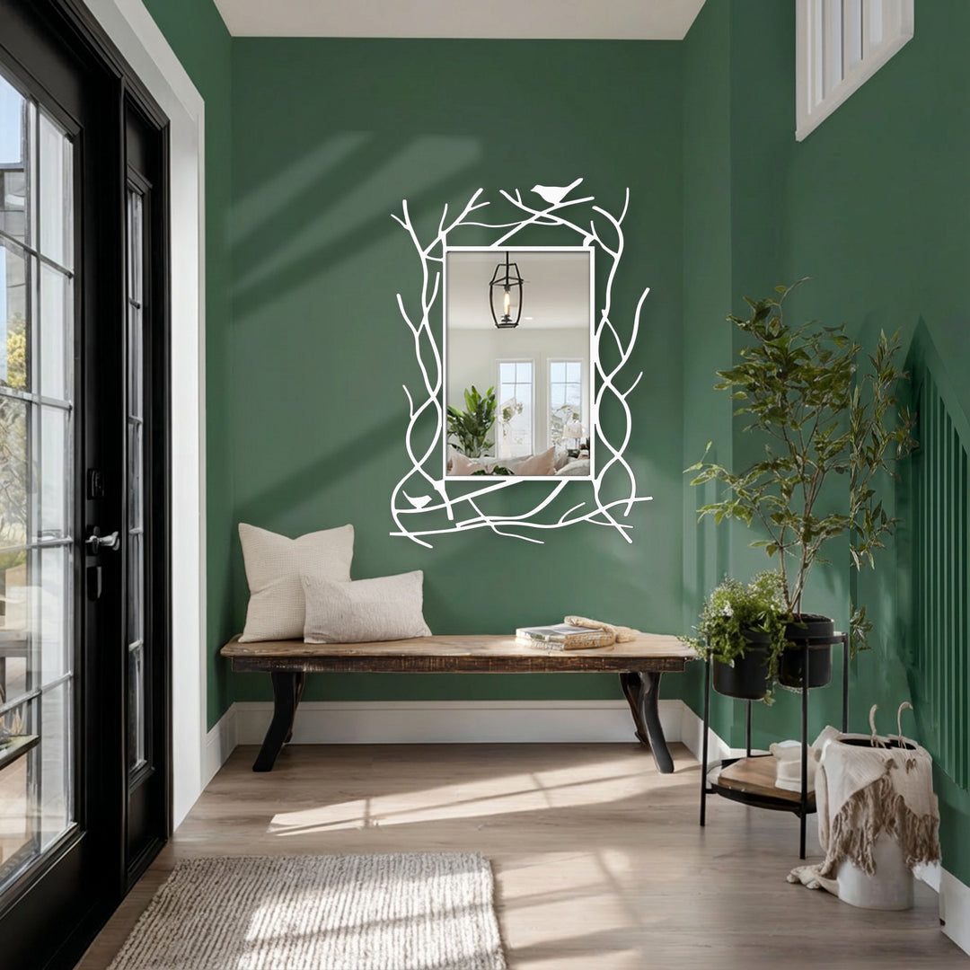 Vertically oriented, the rectangular metal floor mirror showcases a black branch frame with decorative metal art, embellished by a bird detail.