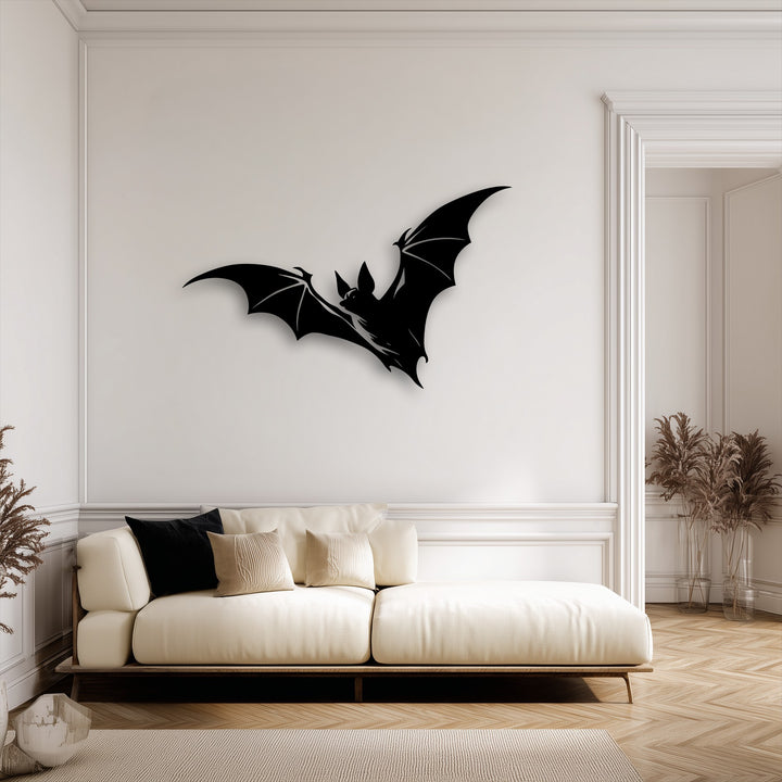 The sleek edges of the flying bat silhouette create striking metal art for wall, framed by elegant decorative molding and a grand doorway.