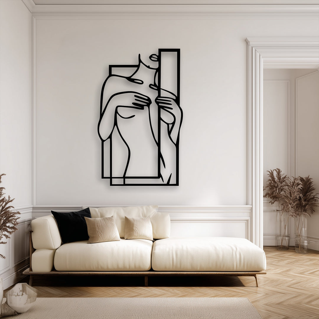 Organic forms beautifully define this minimalist female figure metal artwork, elegantly framed within a geometric design.