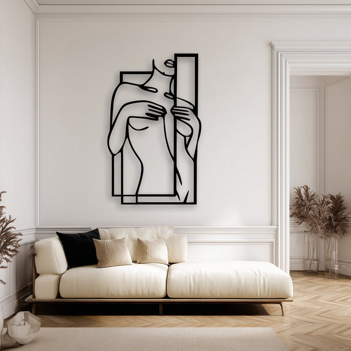 Organic forms beautifully define this minimalist female figure metal artwork, elegantly framed within a geometric design.
