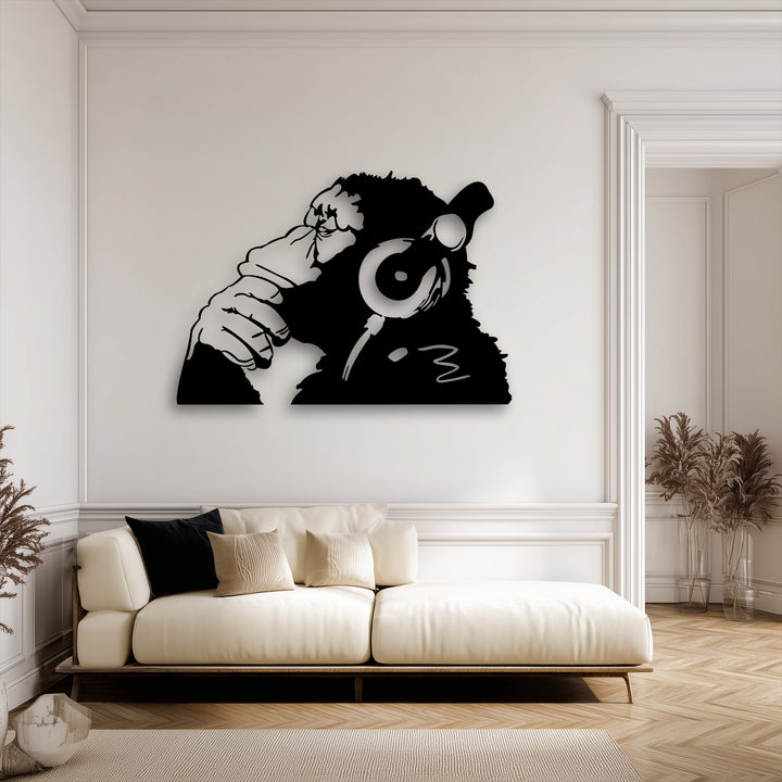 A striking horizontally shaped black metal art for wall featuring a monkey in headphones making a 'Hear No Evil' gesture.