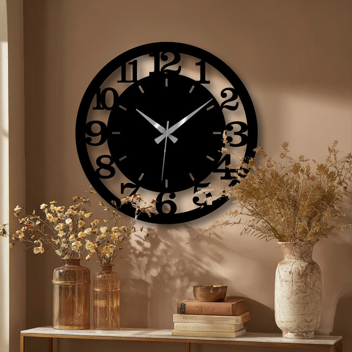 Circular modern numbered hanging wall art is a dark contemporary metal wall clock with a minimalist, open design.