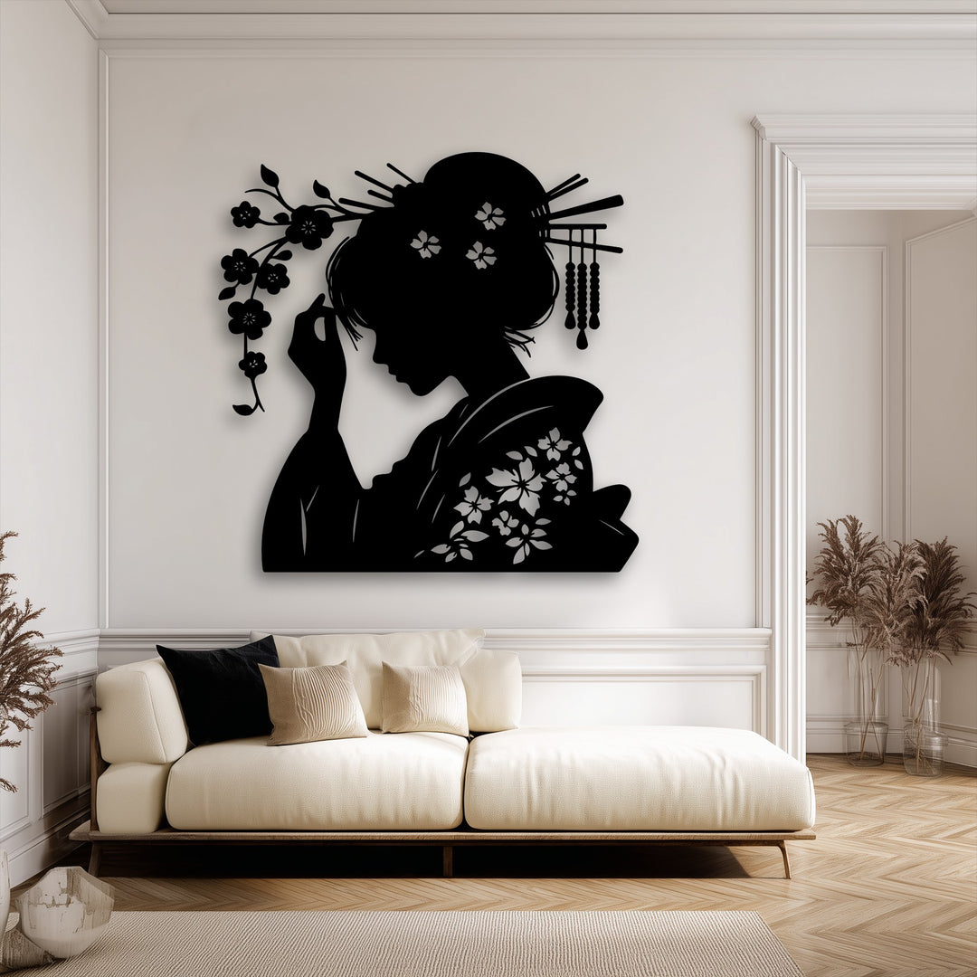 The bold black metal artwork, depicting an elegant geisha oriental silhouette with intricate floral patterns and hair adornments, is the focal point on the light wall.