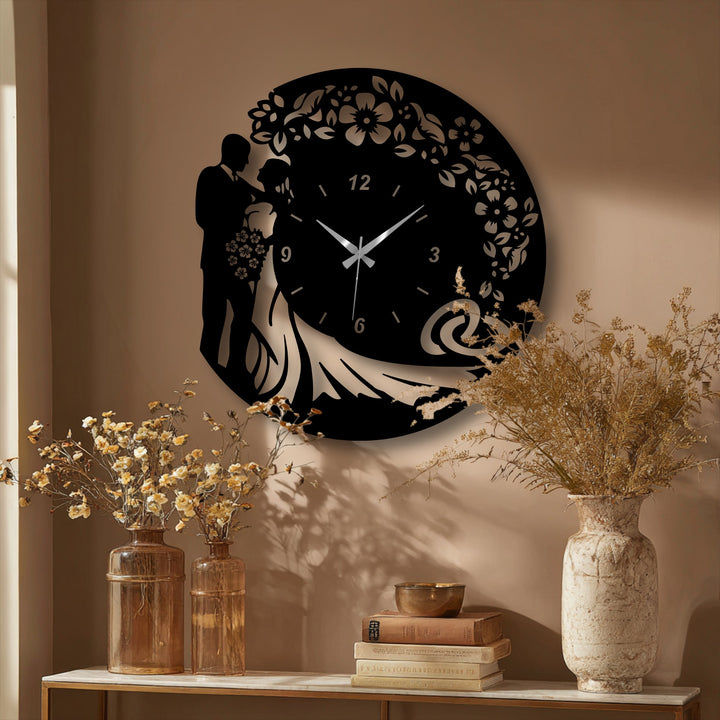 A warm beige wall serves as the backdrop for a romantic wedding silhouette metal wall clock, a unique piece of decoration wall art.