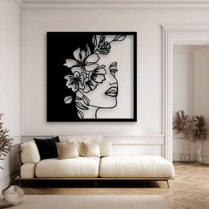 Soft lighting casts soft shadows, enhancing the depth of the elegant floral woman decorative metal art on a bright wall.