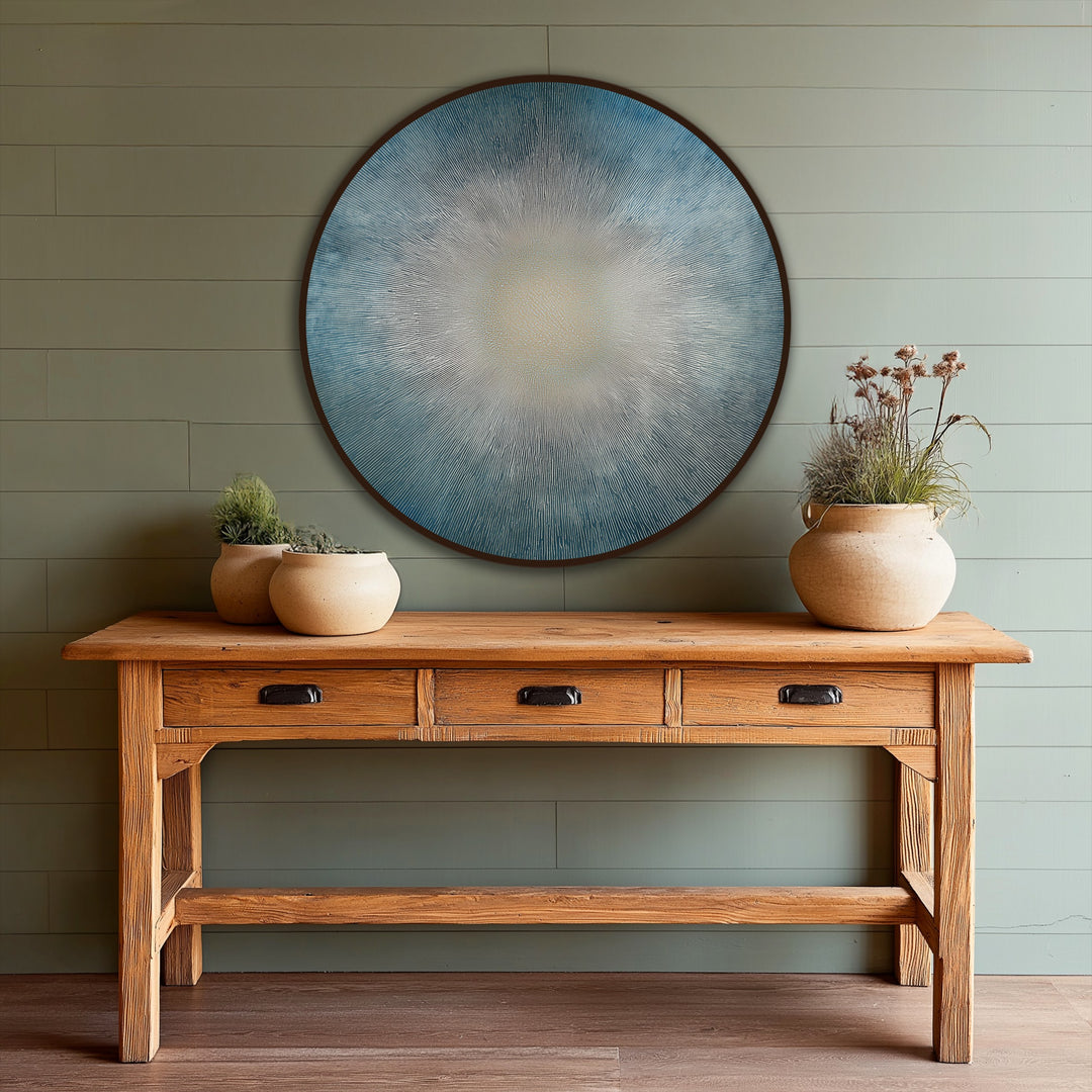 Captured in the focal point, the radiant horizon abstract sunburst round oil painting decoration features a minimalist circular design with hues of blue and a soft, glowing center.