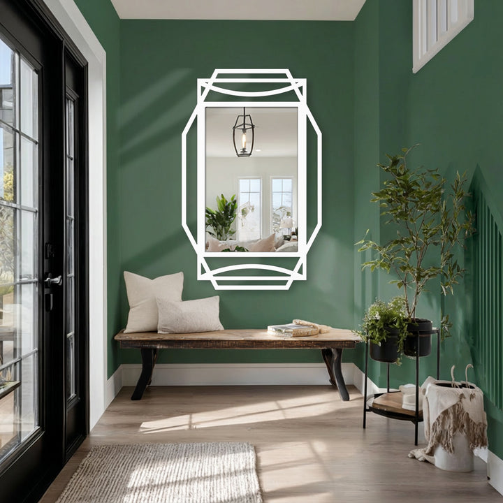 Warm color temperature highlights the reflections in this floor mirror, enhancing the impact of geometric black frame decoration wall art in an inviting entryway.