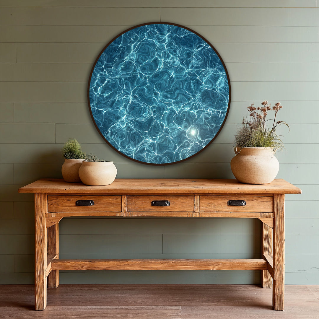 Luminous, round oil painting wall art of an azure current, where the loudest element captures the intense water texture with shimmering light reflections.
