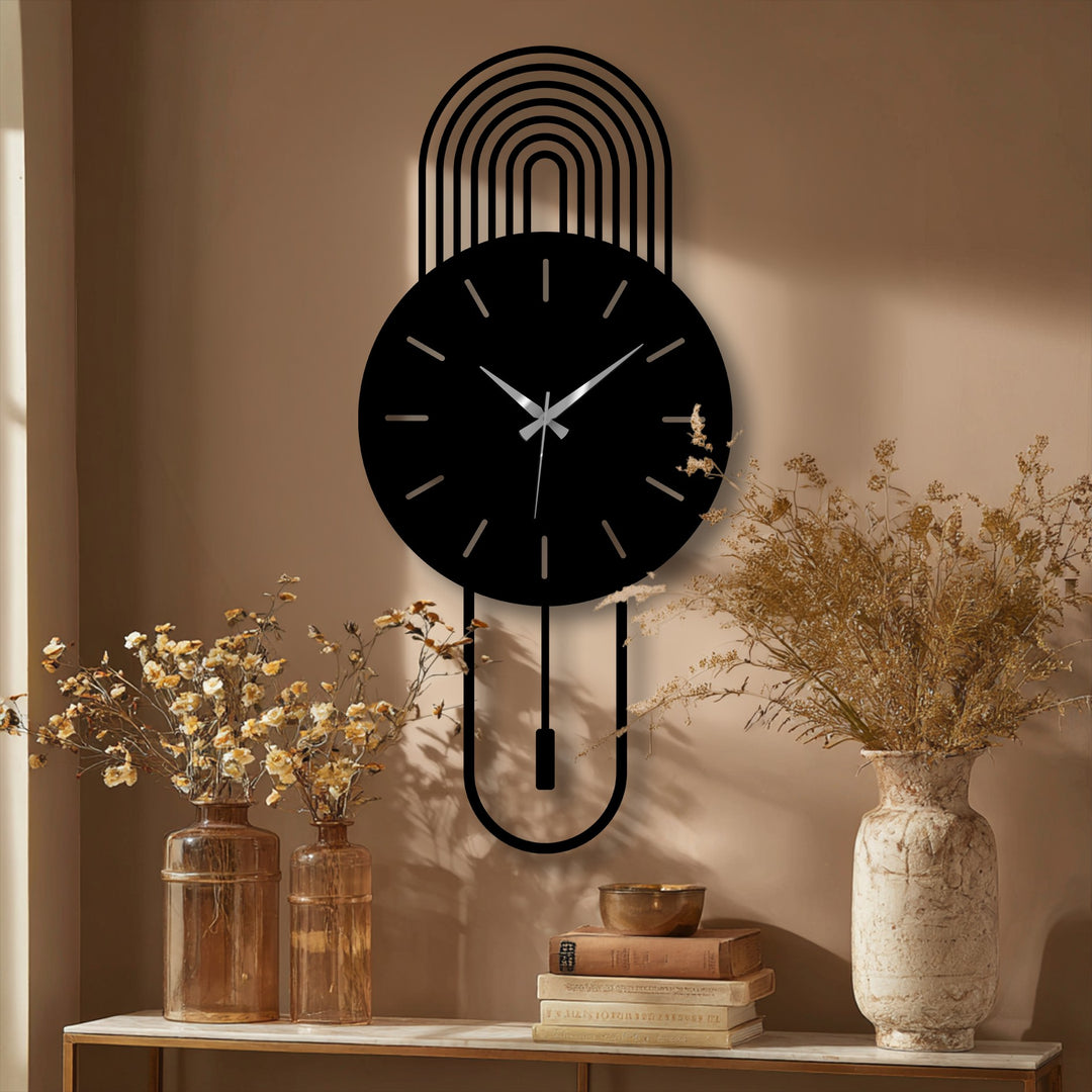 Black matte finish accentuates the modern arc metal wall clock's minimalist pendulum design, offering elegant decorative metal art.