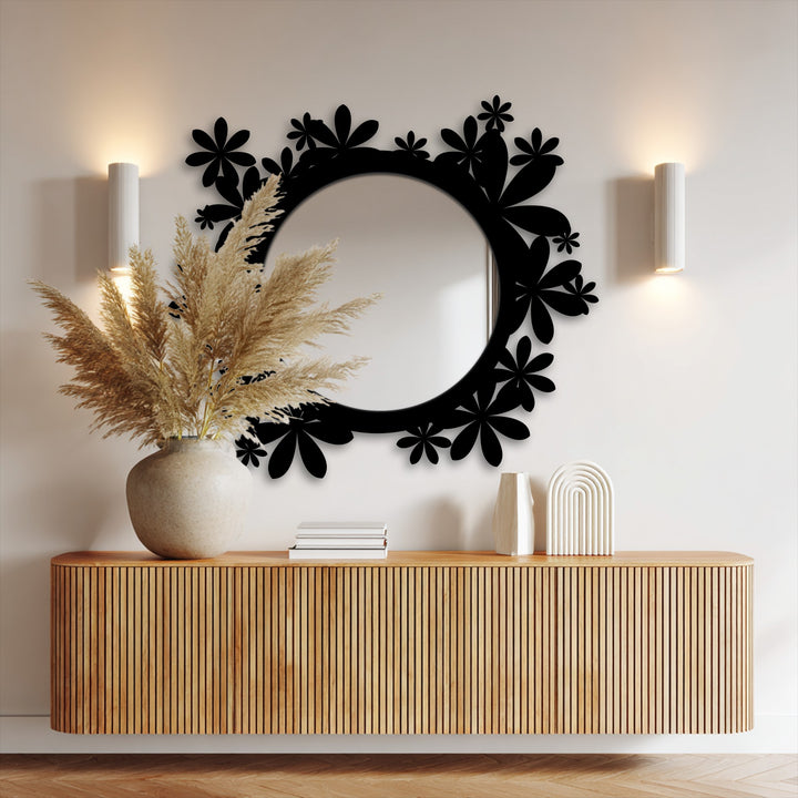 Geometric floral decoration wall art frames a round mirror, enhancing a modern entryway design above a grooved wood console table.