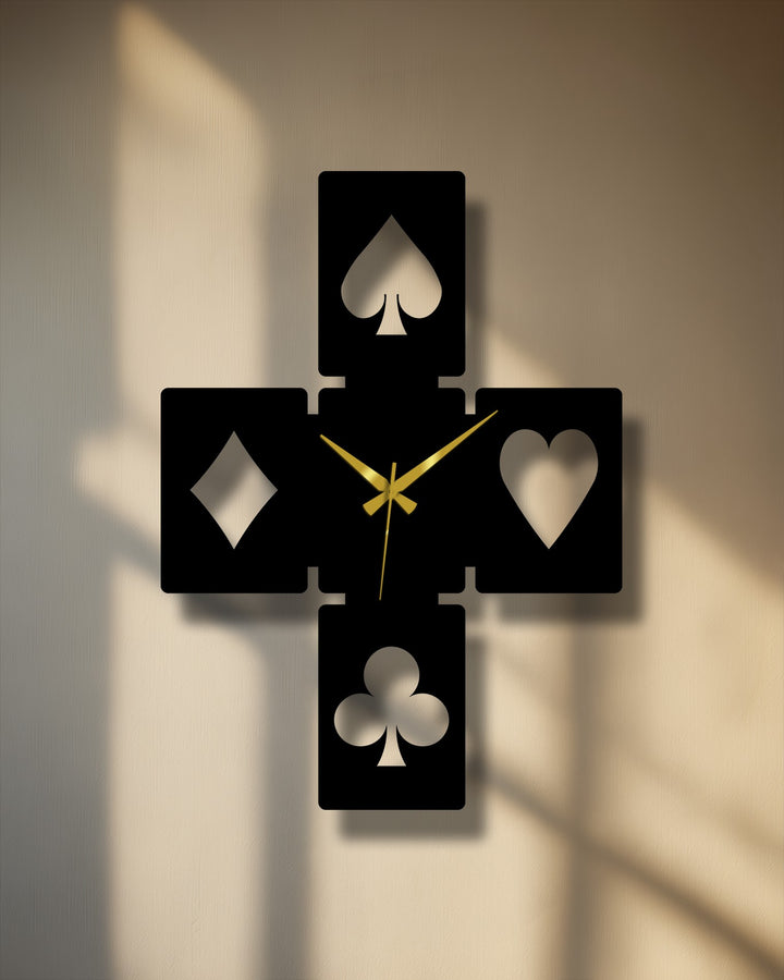 Muted color saturation emphasizes the elegant black playing card symbols metal wall decor with gold hands, casting deep shadows.
