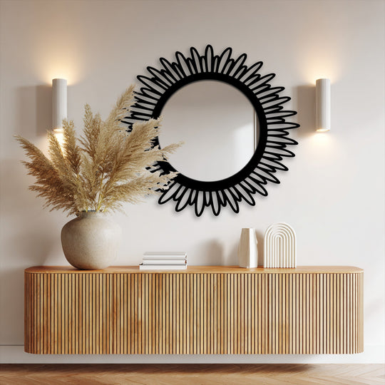 Warm color temperatures highlight a contemporary framed wall mirror with a sunburst petal design, creating a modern and decorative metal wall decor aesthetic.