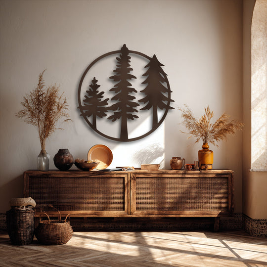 A circular minimalist forest metal art for wall featuring three distinct evergreen trees serves as the focal point above a rustic console.
